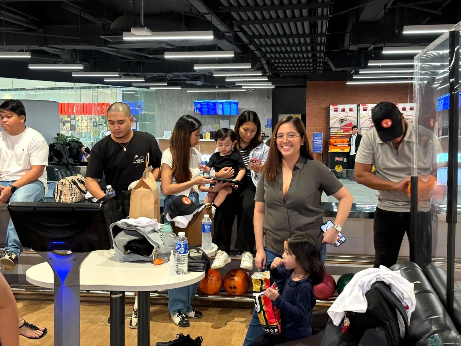 Teammates catching up between games in the bowling alley lounge