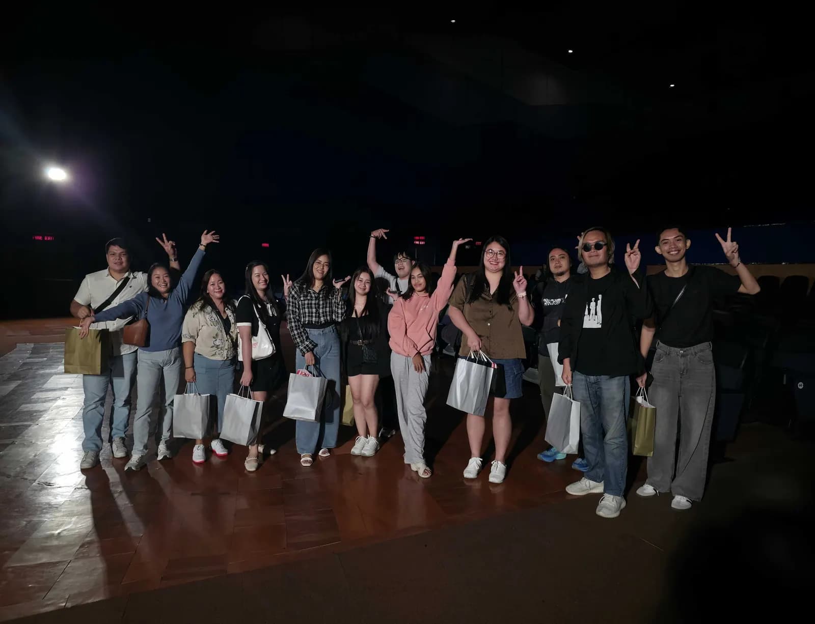 Teammates waving goodnight after the July 2026 movie night, gift bags in hand