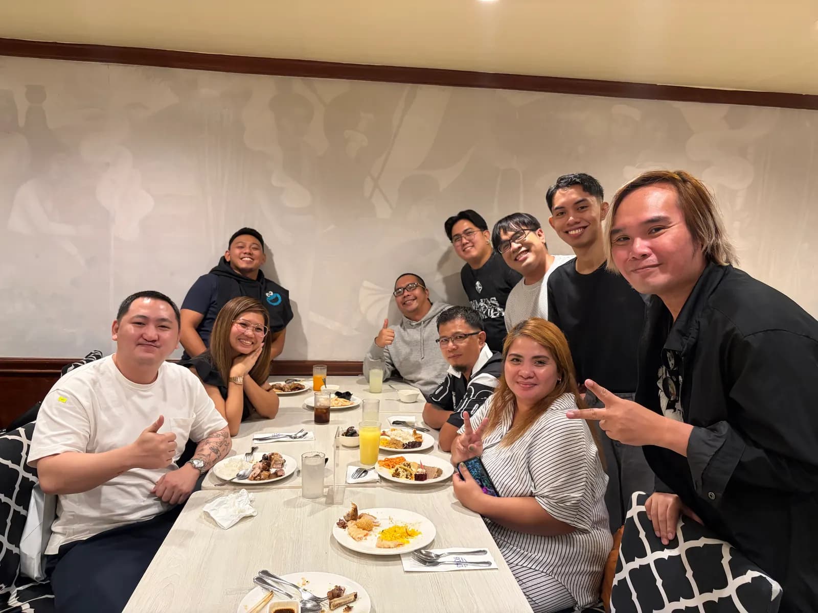 Teammates sharing a meal around a long table at the July 2026 quarterly gathering