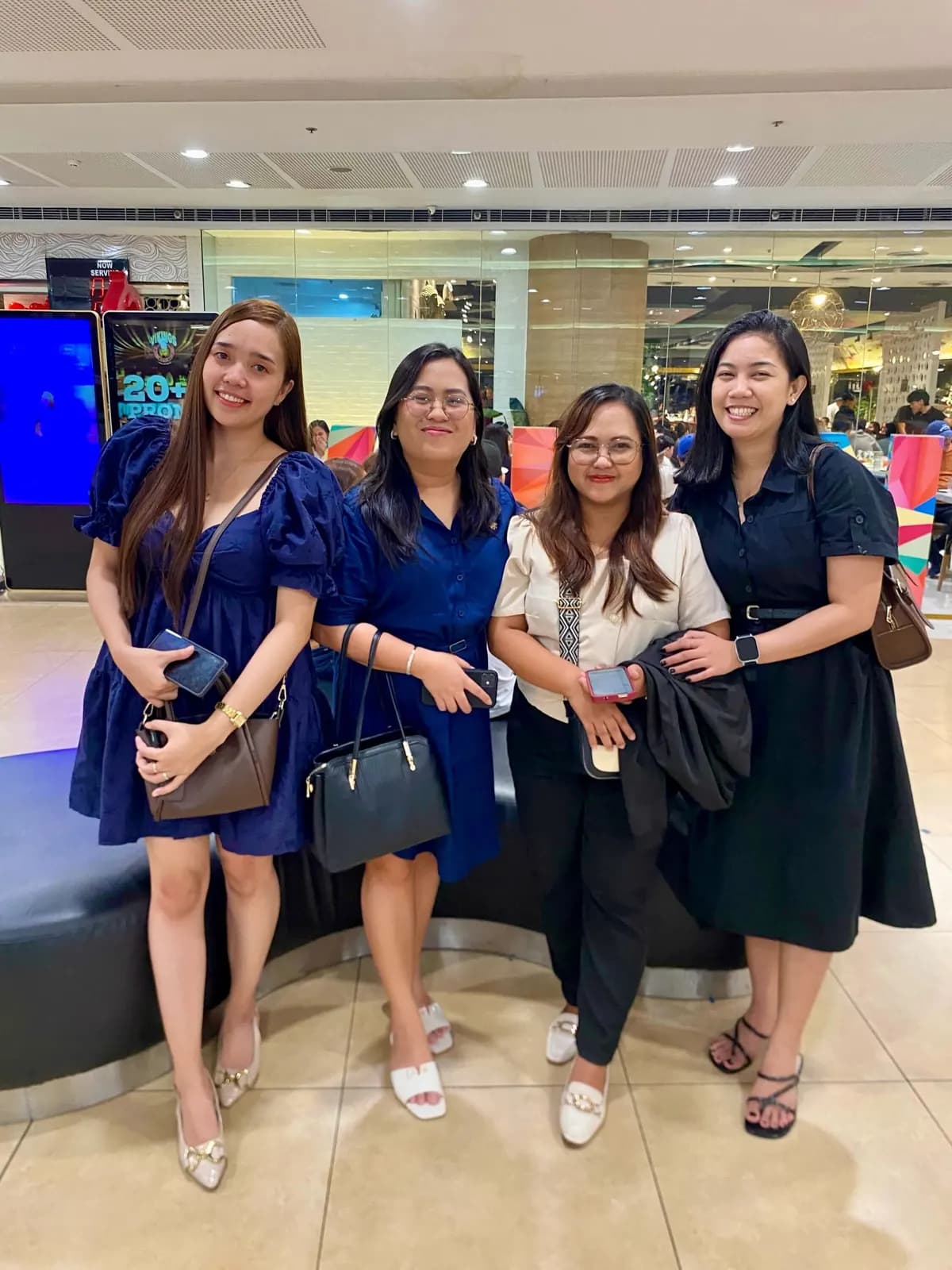 Four teammates in matching blue posing at the mall before the September 2025 screening