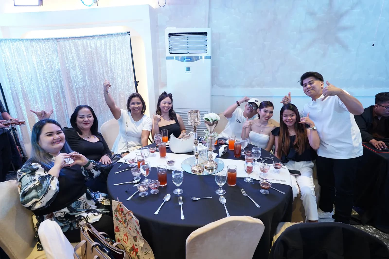 Teammates celebrating around a banquet table at the Black & White Affair year-end party